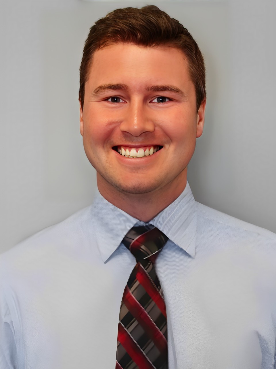 A man in a blue shirt and tie.